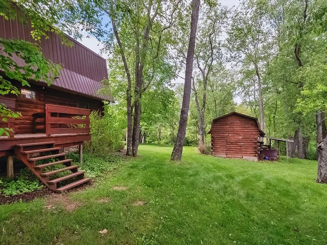 a backyard of a house with table and chairs