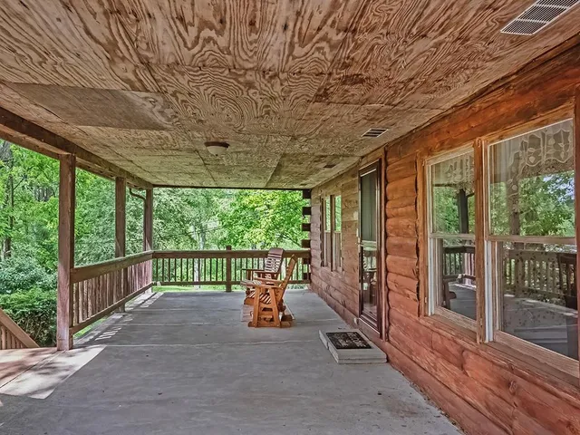 a view of a porch with furniture and floor to ceiling window