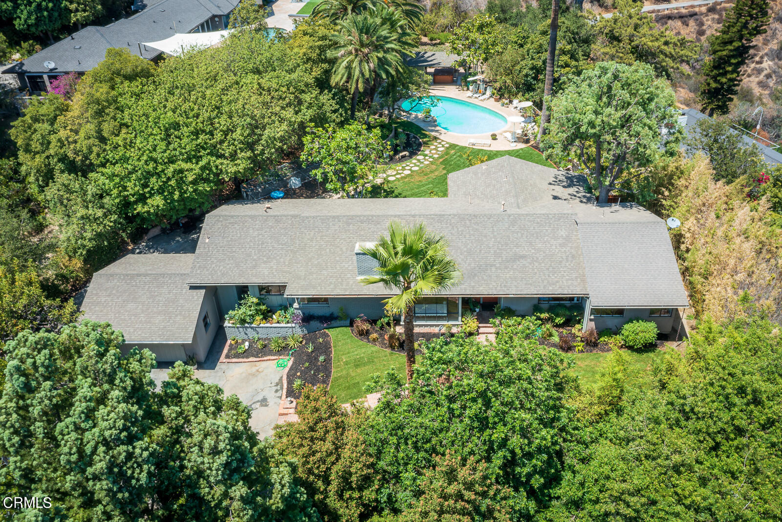an aerial view of a house with garden space and street view