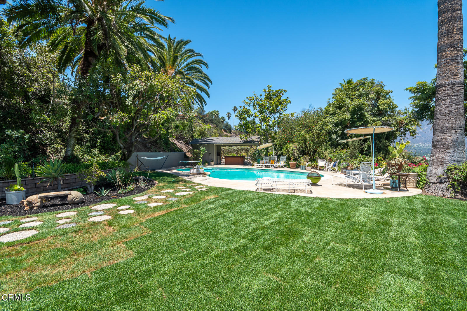 1471 Normandy Drive Pasadena, CA 91103 - Photo 33 of 41 a view of a swimming pool with a table and chairs