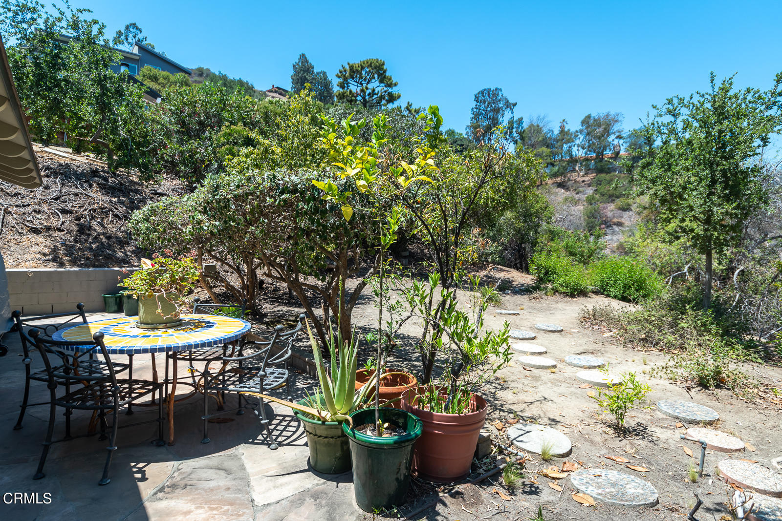 1471 Normandy Drive Pasadena, CA 91103 - Photo 40 of 41 a view of a backyard with table and chairs potted plants and tree