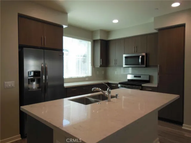 a kitchen with a sink a stove and refrigerator