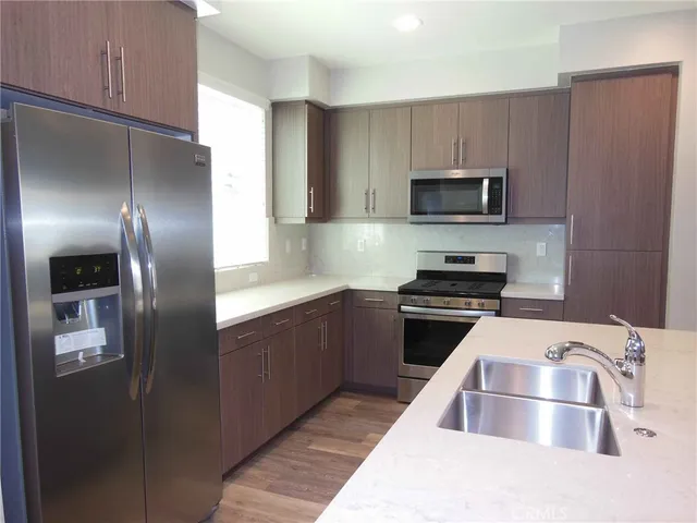 a kitchen with a refrigerator sink and microwave