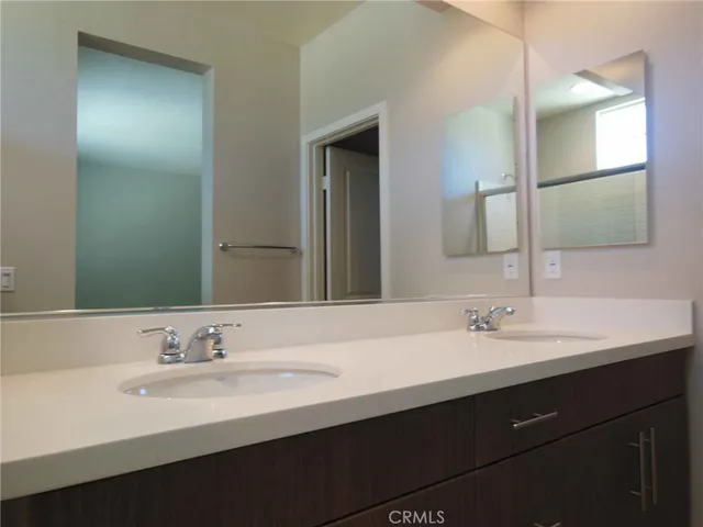 a bathroom with a double vanity sink and a mirror