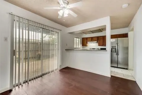 a view of a kitchen with a sink and refrigerator