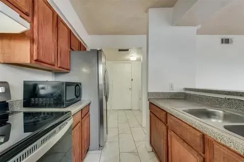 a kitchen with a sink stove and microwave