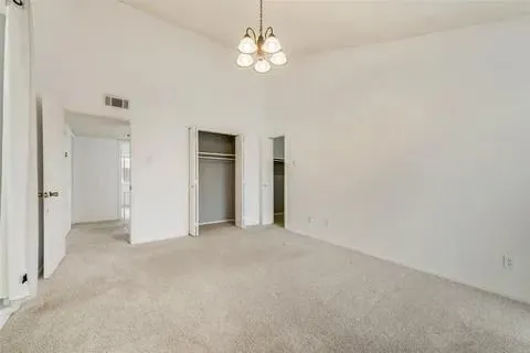 a view of a chandelier fan and refrigerator in a room