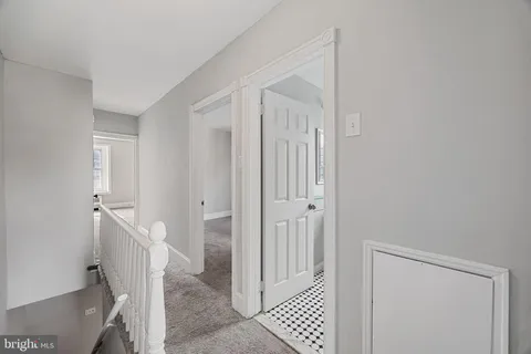 a view of a hallway with closet and wooden floor