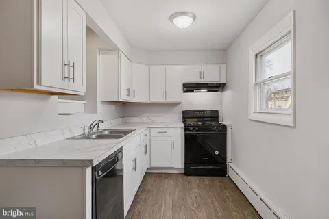 a kitchen with a sink stove and cabinets