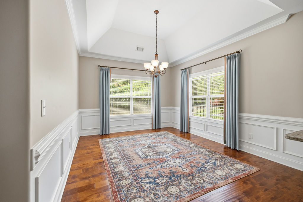 214 Friend Street Anderson, SC 29621 - Photo 11 of 40 This bright room features a chandelier and large windows with natural light.