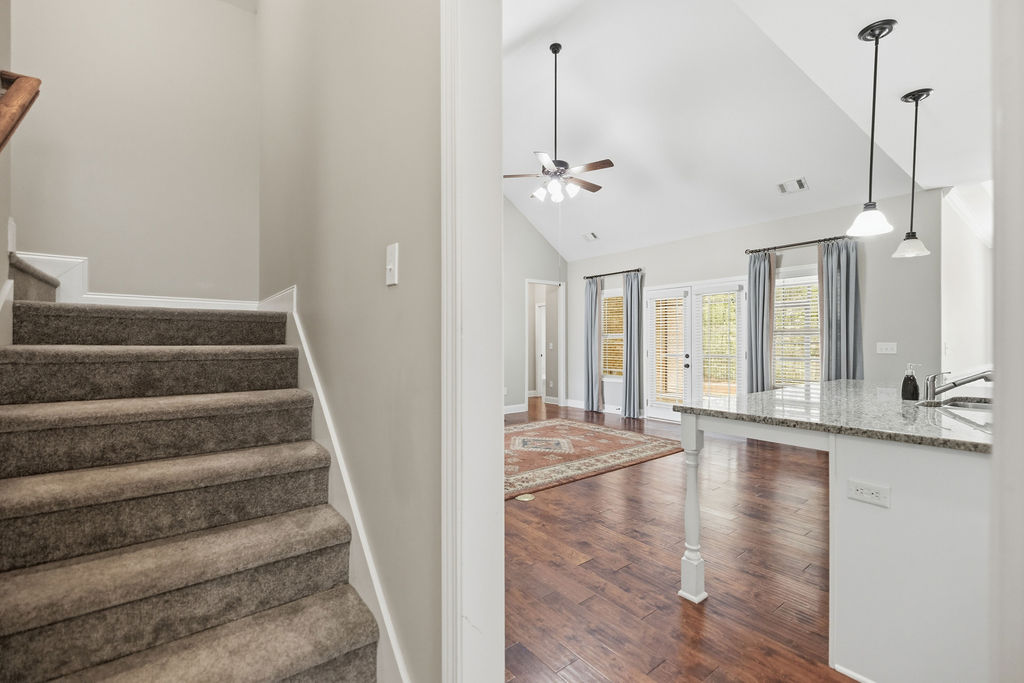 214 Friend Street Anderson, SC 29621 - Photo 16 of 40 This inviting interior features a grand staircase and a bright, open living area with rich hardwood flooring.
