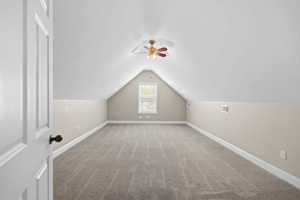 214 Friend Street Anderson, SC 29621 - Photo 17 of 40 This spacious attic conversion offers versatile living space with sloped ceilings and ample natural light.