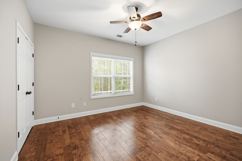 214 Friend Street Anderson, SC 29621 - Photo 22 of 40 This spacious room features hardwood floors and a bright window, creating an inviting atmosphere.