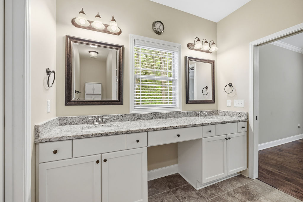 214 Friend Street Anderson, SC 29621 - Photo 27 of 40 This spacious bathroom features a double vanity and elegant granite countertops.