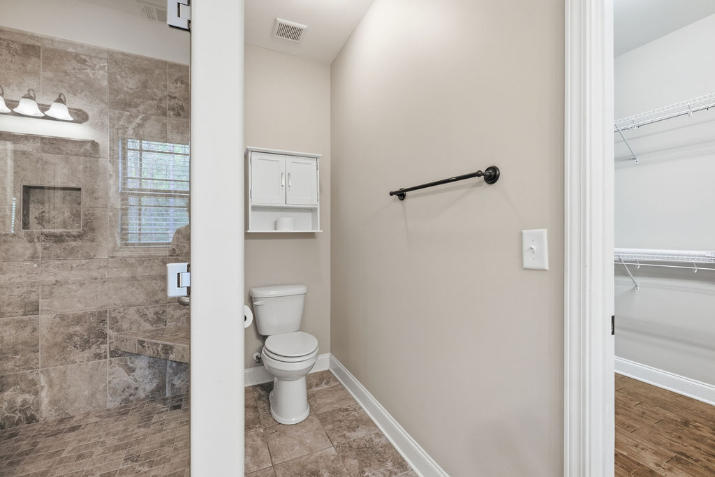 214 Friend Street Anderson, SC 29621 - Photo 28 of 40 This bathroom features a tiled shower and floors, offering both practicality and modern appeal.