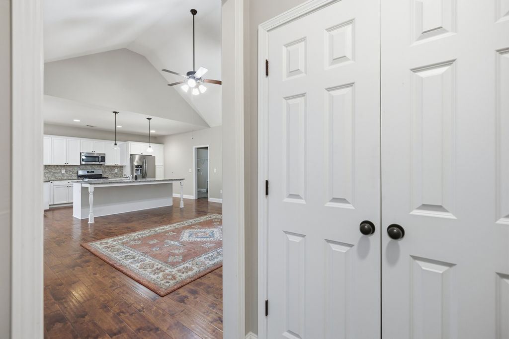 214 Friend Street Anderson, SC 29621 - Photo 30 of 40 This inviting interior features an open-concept design with vaulted ceilings and rich wood flooring.