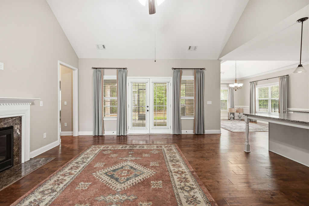 214 Friend Street Anderson, SC 29621 - Photo 31 of 40 An inviting open-concept living space with gleaming hardwood floors, fireplace, and access to outdoor living.