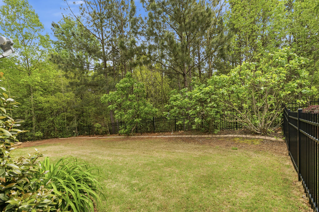 214 Friend Street Anderson, SC 29621 - Photo 35 of 40 This lush, green yard offers a private retreat, bordered by mature trees and secure fencing.