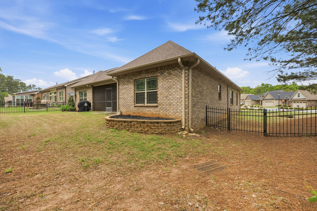 214 Friend Street Anderson, SC 29621 - Photo 37 of 40 This property features a well-maintained exterior with a brick facade and a fenced yard.