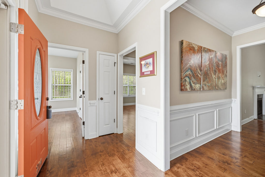 214 Friend Street Anderson, SC 29621 - Photo 4 of 40 Step into this welcoming entryway featuring warm wood floors and classic architectural details.