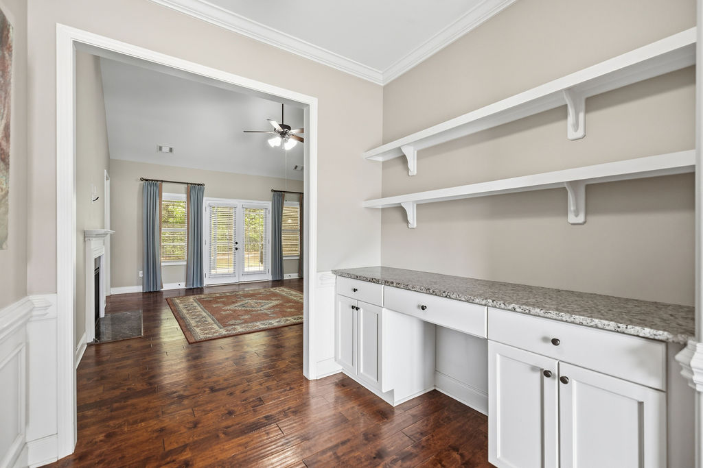 214 Friend Street Anderson, SC 29621 - Photo 5 of 40 This inviting interior features a built-in desk, shelving, and hardwood flooring.