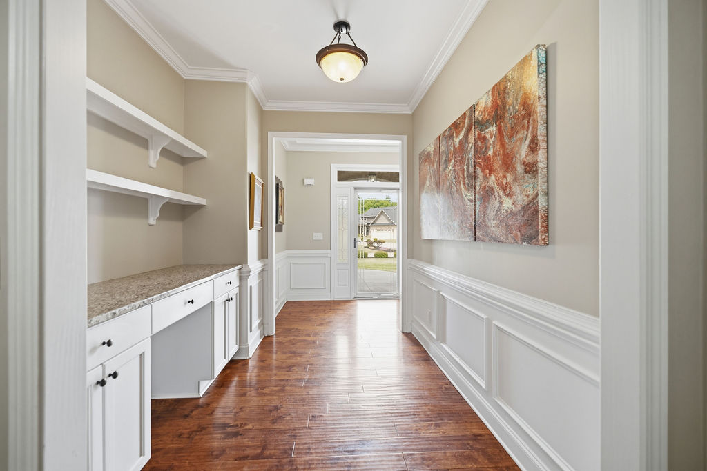 214 Friend Street Anderson, SC 29621 - Photo 6 of 40 This inviting hallway features rich hardwood flooring and elegant wainscoting.