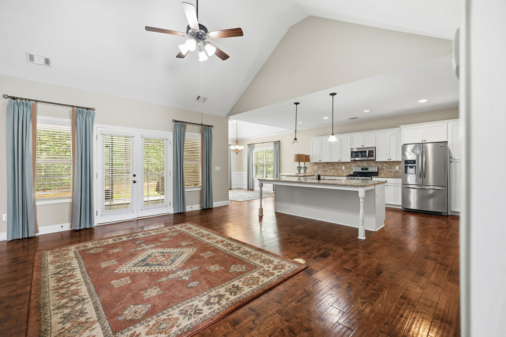 214 Friend Street Anderson, SC 29621 - Photo 7 of 40 An inviting open-concept living area seamlessly connects to a modern kitchen, creating an ideal gathering space.