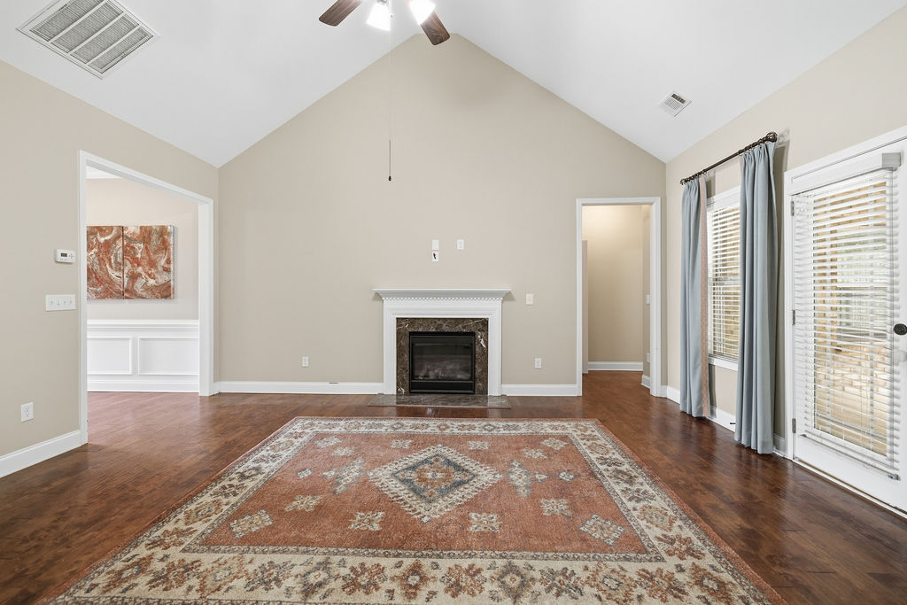 214 Friend Street Anderson, SC 29621 - Photo 8 of 40 This living area features a grand fireplace and vaulted ceilings.
