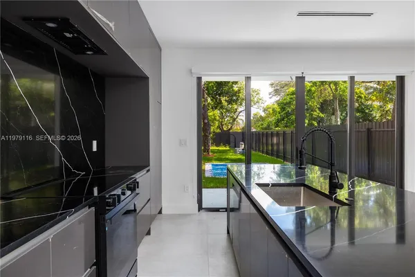 a kitchen with a large window and a sink