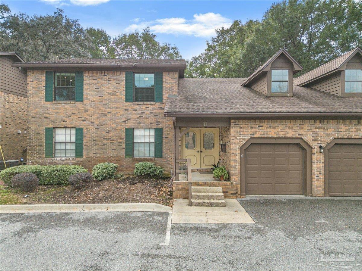 4831 East Olive Road, Unit 1D Pensacola, FL 32514 - Photo 32 of 36 front view of a house with a yard