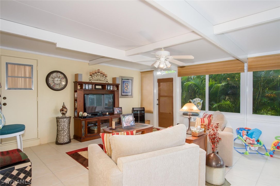 17436 Fuchsia Road Fort Myers, FL 33967 - Photo 18 of 25 a living room with furniture a flat screen tv and a large window