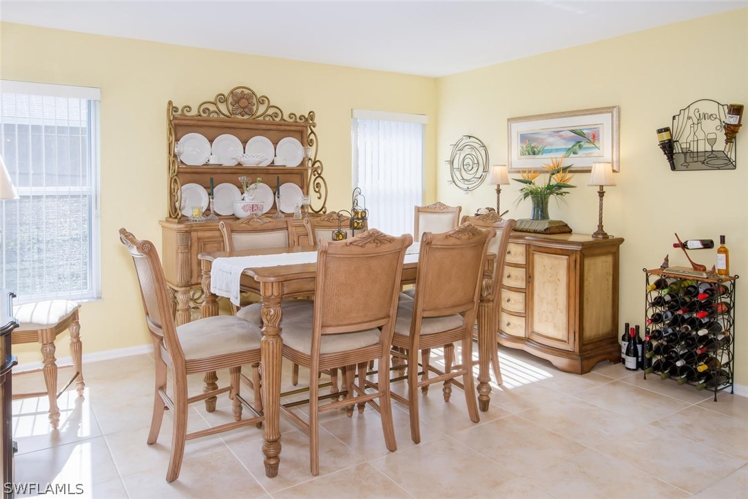 17436 Fuchsia Road Fort Myers, FL 33967 - Photo 8 of 25 a view of a dining room with furniture and a closet
