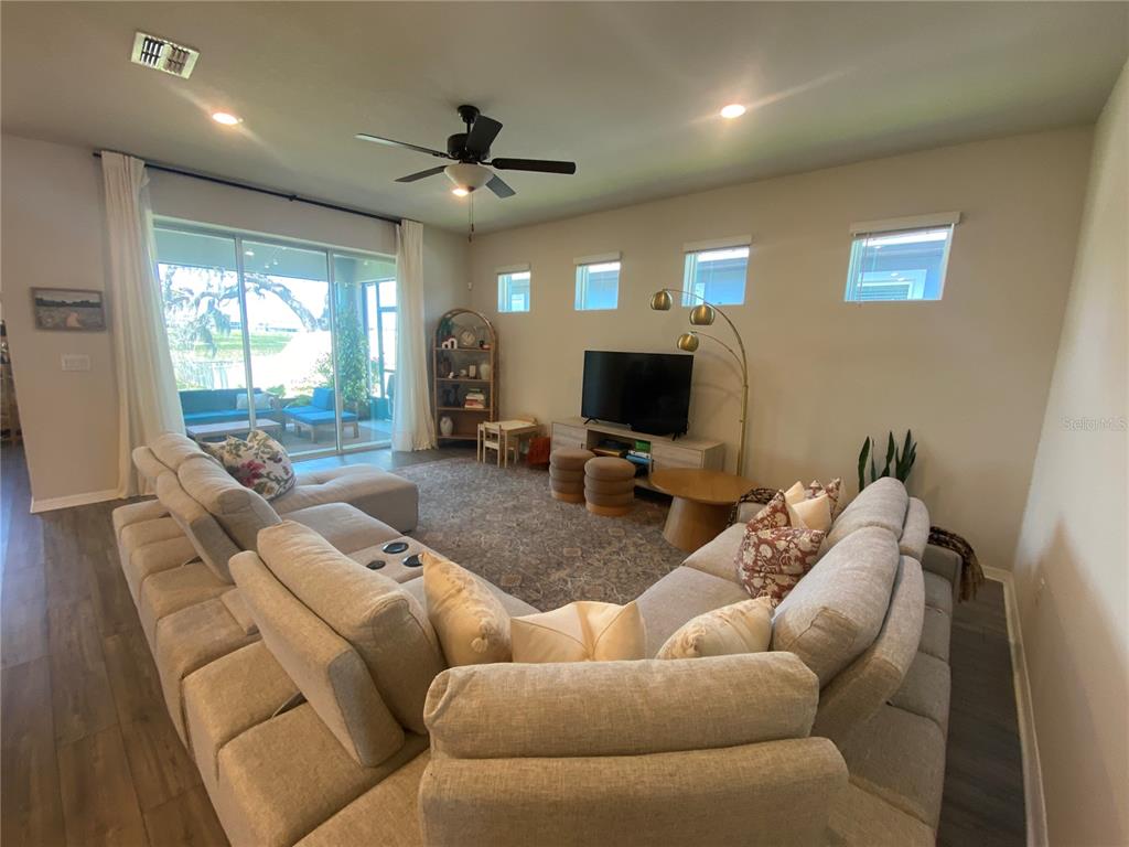 9610 Rally Spring Loop Wesley Chapel, FL 33545 - Photo 4 of 38 a living room with furniture and a flat screen tv
