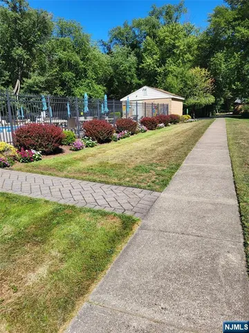 a view of swimming pool in front of house