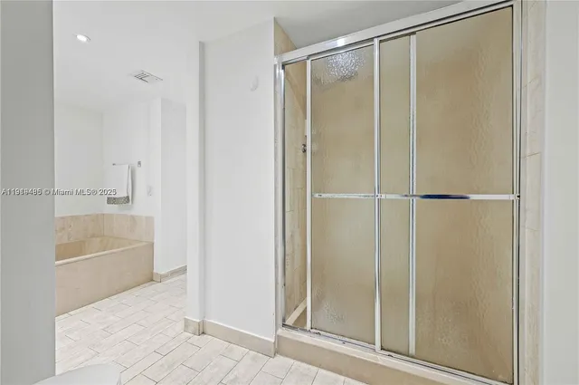 a bathroom with a bathtub and a shower