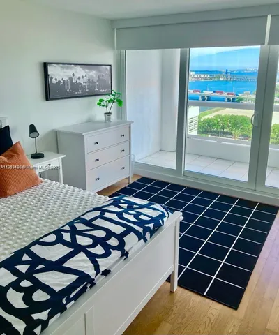 a bedroom with bed and a window