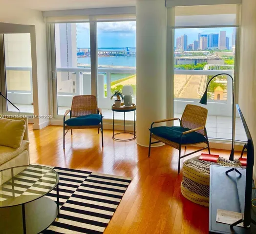 a living room with furniture and a floor to ceiling window
