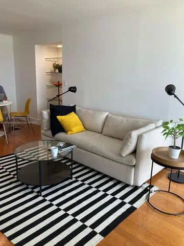 a living room with furniture and a lamp