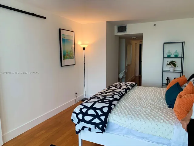 a bedroom with a bed and a table