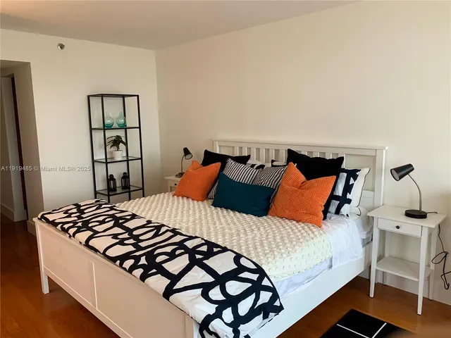 a bedroom with a bed and dresser