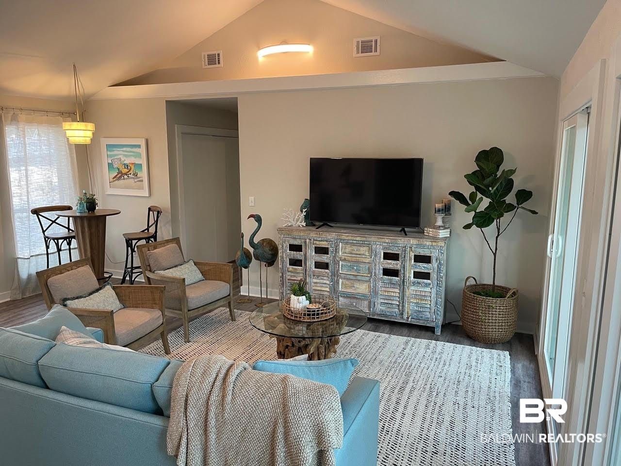 413 West Fort Morgan Road Gulf Shores, AL 36542 - Photo 8 of 29 Living room with wood finished floors, vaulted ceiling, and visible vents