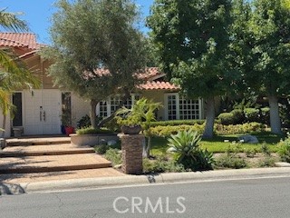 10821 Vida Drive, Unit 4 Villa Park, CA 92861 - Photo 1 of 6 a view of a house with potted plants and large trees