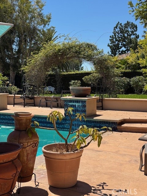 10821 Vida Drive, Unit 4 Villa Park, CA 92861 - Photo 6 of 6 a view of a swimming pool with a patio
