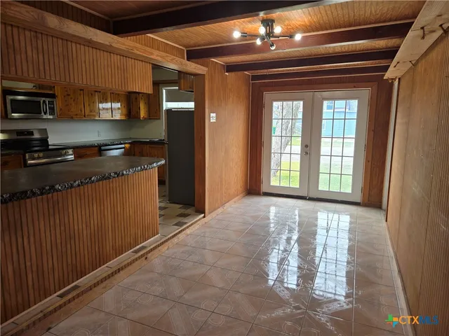 a kitchen with stainless steel appliances granite countertop a refrigerator and a stove top oven