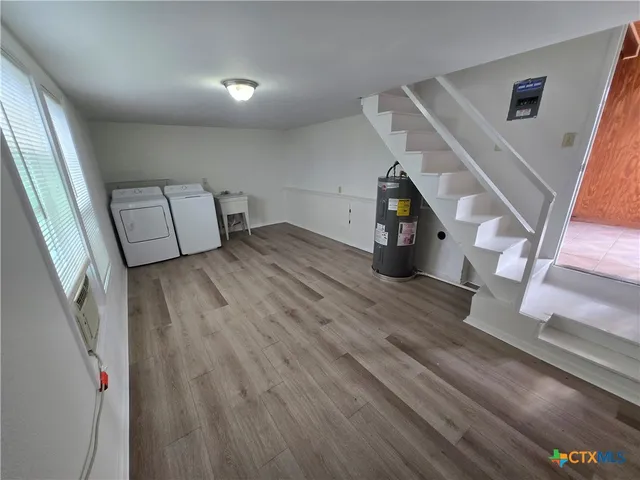 a view of entryway and hall with wooden floor