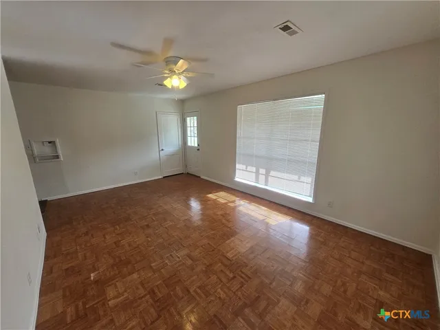 an empty room with a empty space and a window