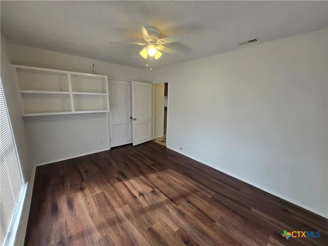 a view of an empty room and wooden floor