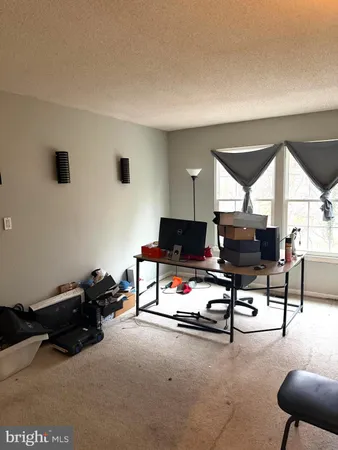 a living room with furniture gym equipment and a view of living room