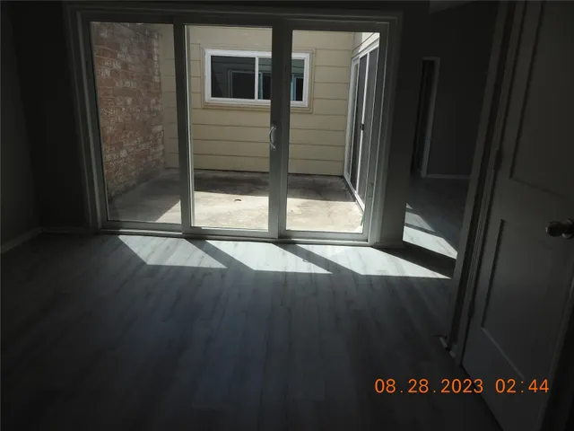 a view of an entryway with wooden floor