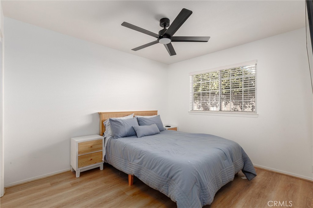 341 North 4th Street Grover Beach, CA 93433 - Photo 18 of 33 a bedroom with a bed and wooden floor